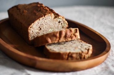 close up photo of sliced bread on oval wooden plate