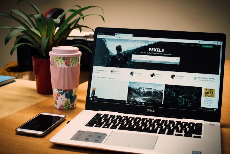 photo of a gray dell laptop displaying pexels webpage