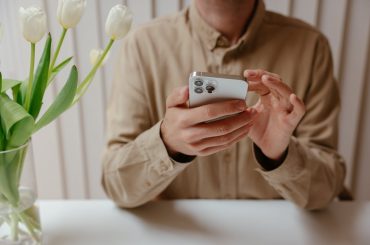 person in white dress shirt holding white samsung android smartphone