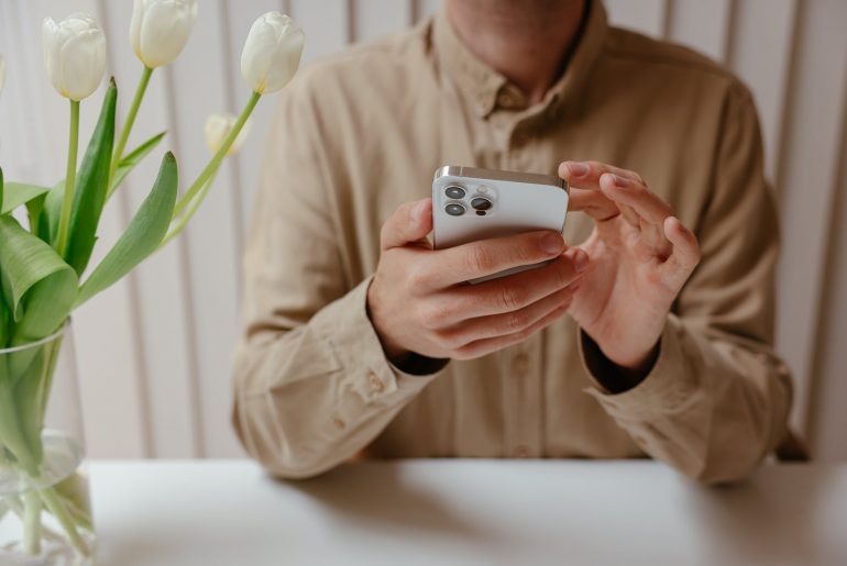 person in white dress shirt holding white samsung android smartphone