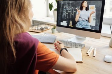 photo of girl watching through imac